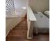 View of stairs leading to bedroom with hardwood floors, a gray bed, and a cozy atmosphere at 6328 Raleigh St # 814, Orlando, FL 32835