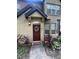 Inviting front entrance with a decorative wreath on the red door and well-maintained landscaping at 6328 Raleigh St # 814, Orlando, FL 32835