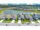 Aerial view of a neighborhood with homes surrounding a beautiful lake at 633 Greymount St, Davenport, FL 33837