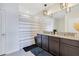 Bathroom featuring double sinks, granite countertops, updated fixtures, and a shower with striped curtain at 633 Greymount St, Davenport, FL 33837