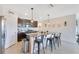 A modern kitchen with stainless-steel appliances, a large center island, and a pantry closet at 633 Greymount St, Davenport, FL 33837