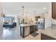 This kitchen features stainless steel appliances, granite countertops, a center island and flows into the living area at 633 Greymount St, Davenport, FL 33837