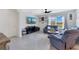 Relaxing living room with tile flooring, a ceiling fan, and large windows with great backyard views at 633 Greymount St, Davenport, FL 33837