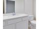 Clean, modern bathroom with a white vanity and a large mirror at 6331 Breeze Filled Ln, Winter Garden, FL 34787