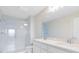 Bright bathroom featuring double sinks with sleek white cabinetry, a subway-tiled shower, and contemporary fixtures at 6331 Breeze Filled Ln, Winter Garden, FL 34787
