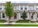 Charming townhome showcasing meticulous landscaping, a well-maintained lawn, and a welcoming front entrance at 6331 Breeze Filled Ln, Winter Garden, FL 34787