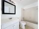 Bathroom featuring tiled shower-tub, white vanity and framed mirror at 645 Stafford Ter # 163, Altamonte Springs, FL 32714