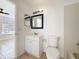 Bathroom featuring a tiled shower-tub combo, and a square mirror with black frame at 645 Stafford Ter # 163, Altamonte Springs, FL 32714