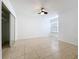 Bright bedroom with neutral tile flooring, ceiling fan and large window with blinds at 645 Stafford Ter # 163, Altamonte Springs, FL 32714