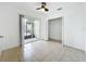 Light and airy bedroom with tile flooring, closet, ceiling fan and screened patio access at 645 Stafford Ter # 163, Altamonte Springs, FL 32714