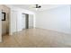 Bright bedroom with neutral tile flooring, ceiling fan and closet with mirrored doors at 645 Stafford Ter # 163, Altamonte Springs, FL 32714