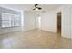 Bright bedroom with neutral tile flooring, ceiling fan and a large window at 645 Stafford Ter # 163, Altamonte Springs, FL 32714