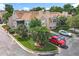 Exterior angle of a townhome with well-kept landscaping, reserved parking, and outdoor patio at 645 Stafford Ter # 163, Altamonte Springs, FL 32714
