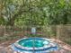 Community hot tub surrounded by a metal fence and rules for pool use at 645 Stafford Ter # 163, Altamonte Springs, FL 32714