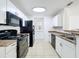 Bright, tiled kitchen with white cabinets, modern appliances and generous counter space at 645 Stafford Ter # 163, Altamonte Springs, FL 32714