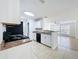 Tiled kitchen featuring white cabinets, stainless sink and an open view into the bright living room at 645 Stafford Ter # 163, Altamonte Springs, FL 32714