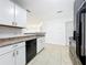 Bright kitchen featuring white cabinets, neutral countertops, and a stainless steel sink at 645 Stafford Ter # 163, Altamonte Springs, FL 32714