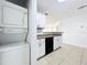 Bright kitchen featuring stackable washer/dryer and neutral countertops and a stainless steel sink at 645 Stafford Ter # 163, Altamonte Springs, FL 32714