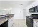 Bright kitchen featuring white cabinets, neutral countertops, and black oven/microwave combo at 645 Stafford Ter # 163, Altamonte Springs, FL 32714