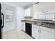 Bright kitchen featuring white cabinets, neutral countertops, and a stainless steel sink at 645 Stafford Ter # 163, Altamonte Springs, FL 32714