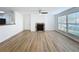 Spacious living room showcasing wood floors, a fireplace and large windows for natural light at 645 Stafford Ter # 163, Altamonte Springs, FL 32714