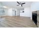 Open-concept living room boasts wood-look flooring, neutral walls, a fireplace, and access to the kitchen at 645 Stafford Ter # 163, Altamonte Springs, FL 32714