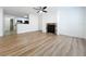 Living room featuring wood floors, ceiling fan and a fireplace with decorative stone surround at 645 Stafford Ter # 163, Altamonte Springs, FL 32714