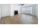 Bright living room features laminate wood flooring, fireplace, and large windows for natural light at 645 Stafford Ter # 163, Altamonte Springs, FL 32714