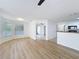 Bright living room with wood floors, abundant natural light and views into kitchen and outdoor patio at 645 Stafford Ter # 163, Altamonte Springs, FL 32714