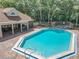 A lovely fenced community pool with attached lounging and grilling area surrounded by mature trees at 645 Stafford Ter # 163, Altamonte Springs, FL 32714