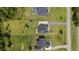 Overhead aerial view of property and surrounding community, including lawn, nearby homes and greenery at 7191 Old Melbourne Hwy, St Cloud, FL 34771