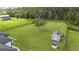 Large backyard with manicured lawn, mature tree, shed and wishing well at 7191 Old Melbourne Hwy, St Cloud, FL 34771