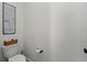 Cozy bathroom featuring a toilet, decorative art, and toilet paper storage on the tank at 7191 Old Melbourne Hwy, St Cloud, FL 34771