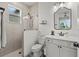 Bathroom showcasing a glass-enclosed shower, vanity with storage, and decorative floor tiles at 7191 Old Melbourne Hwy, St Cloud, FL 34771