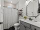 Bathroom features patterned floor tiles, a shower with curtain, and a modern vanity at 7191 Old Melbourne Hwy, St Cloud, FL 34771