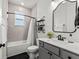 Bright bathroom with bathtub, tiled wall, patterned floor, and modern vanity at 7191 Old Melbourne Hwy, St Cloud, FL 34771