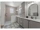 Bathroom featuring a gray vanity with dual sinks and a modern tiled shower at 7191 Old Melbourne Hwy, St Cloud, FL 34771
