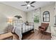 Cozy bedroom with ceiling fan, hardwood floors, chair and window at 7191 Old Melbourne Hwy, St Cloud, FL 34771