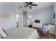 Comfortable bedroom with ceiling fan, hardwood floors, rocking chair and television console at 7191 Old Melbourne Hwy, St Cloud, FL 34771