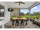 Screened patio with ceiling fan, dining table and chairs, offering outdoor eating near a view at 7191 Old Melbourne Hwy, St Cloud, FL 34771