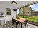 Covered patio with ceiling fan, dining table and chairs, offering outdoor eating with counter at 7191 Old Melbourne Hwy, St Cloud, FL 34771