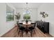 Well-lit dining room with a wooden table, black chairs, modern lighting, and tasteful decorations at 7191 Old Melbourne Hwy, St Cloud, FL 34771