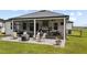 Rear exterior featuring screened patio with dining, kitchen, and lounge areas with exterior patio at 7191 Old Melbourne Hwy, St Cloud, FL 34771
