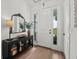 Inviting foyer with console table, statement mirror, and a bright white front door with sidelights at 7191 Old Melbourne Hwy, St Cloud, FL 34771