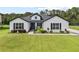 Charming two-story home with a beautifully landscaped yard, a blue door and dark shutters at 7191 Old Melbourne Hwy, St Cloud, FL 34771