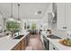 Bright open kitchen with a large island, stainless steel appliances, and seamless transition to the dining area at 7191 Old Melbourne Hwy, St Cloud, FL 34771