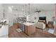 Open kitchen and living area featuring modern appliances, an island with a sink, and comfortable seating at 7191 Old Melbourne Hwy, St Cloud, FL 34771