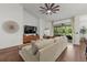 Inviting living room with hardwood floors, plush sofa, and view of the outdoor patio through sliding glass doors at 7191 Old Melbourne Hwy, St Cloud, FL 34771