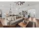 Open-concept living room with hardwood floors, stylish furnishings, and modern lighting fixtures at 7191 Old Melbourne Hwy, St Cloud, FL 34771
