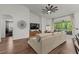 Cozy living room showcasing a stylish sectional sofa, hardwood floors, and seamless indoor/outdoor flow at 7191 Old Melbourne Hwy, St Cloud, FL 34771